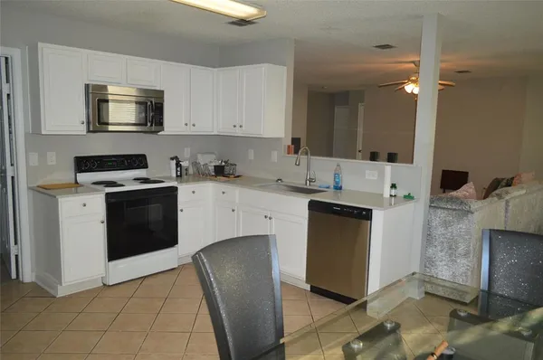 a kitchen with a sink stove and microwave