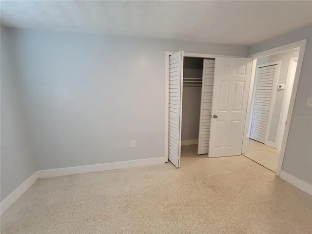 a view of an empty room and closet area