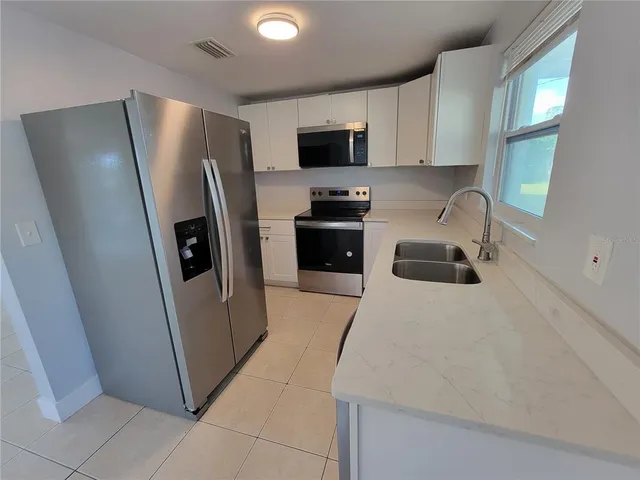a kitchen with a refrigerator sink and microwave