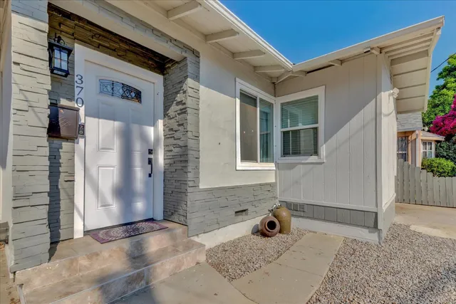 a view of a brick house with potted plants