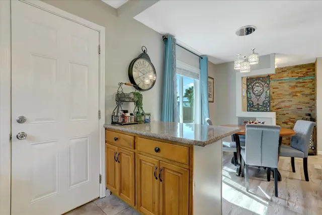 a view of a dining room with furniture and chandelier
