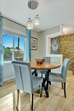 a view of a dining area with furniture and wooden floor