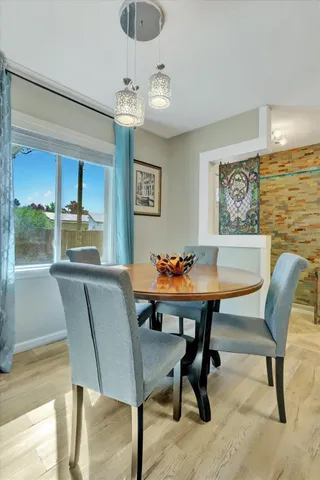 a view of a dining area with furniture and wooden floor