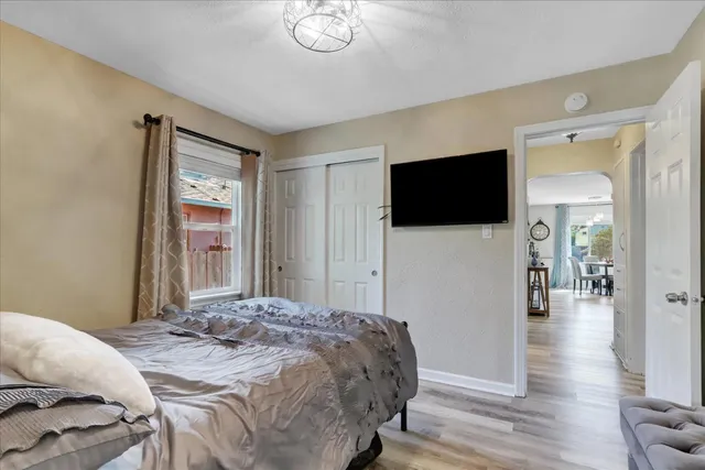 a bedroom with a bed and wooden floor