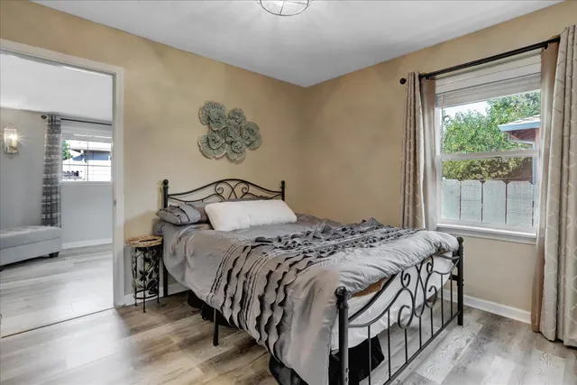 a bedroom with a bed and a chandelier