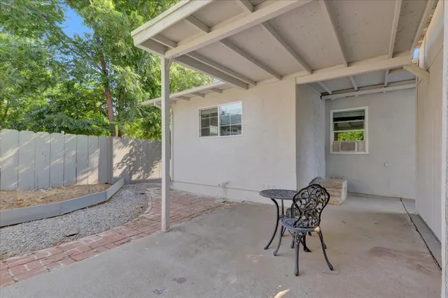 a backyard of a house with table and chairs
