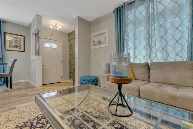 a living room with furniture rug and window