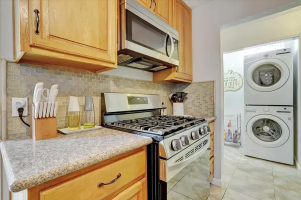 a kitchen with stainless steel appliances granite countertop a sink and cabinets