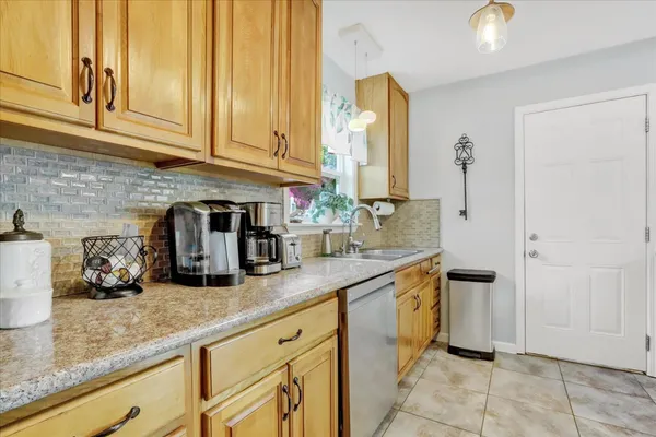 a kitchen with a sink a stove and cabinets
