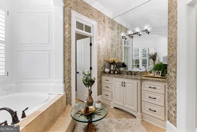 a bedroom with bed and a chandelier