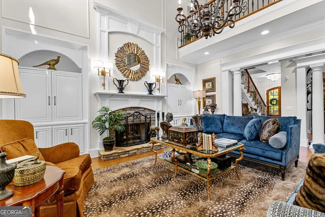 a living room with fireplace furniture and a potted plant