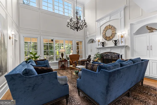 a living room with fireplace furniture and a flat screen tv