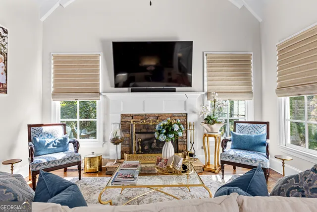 a large kitchen with stainless steel appliances a large counter top a stove and a wooden floors