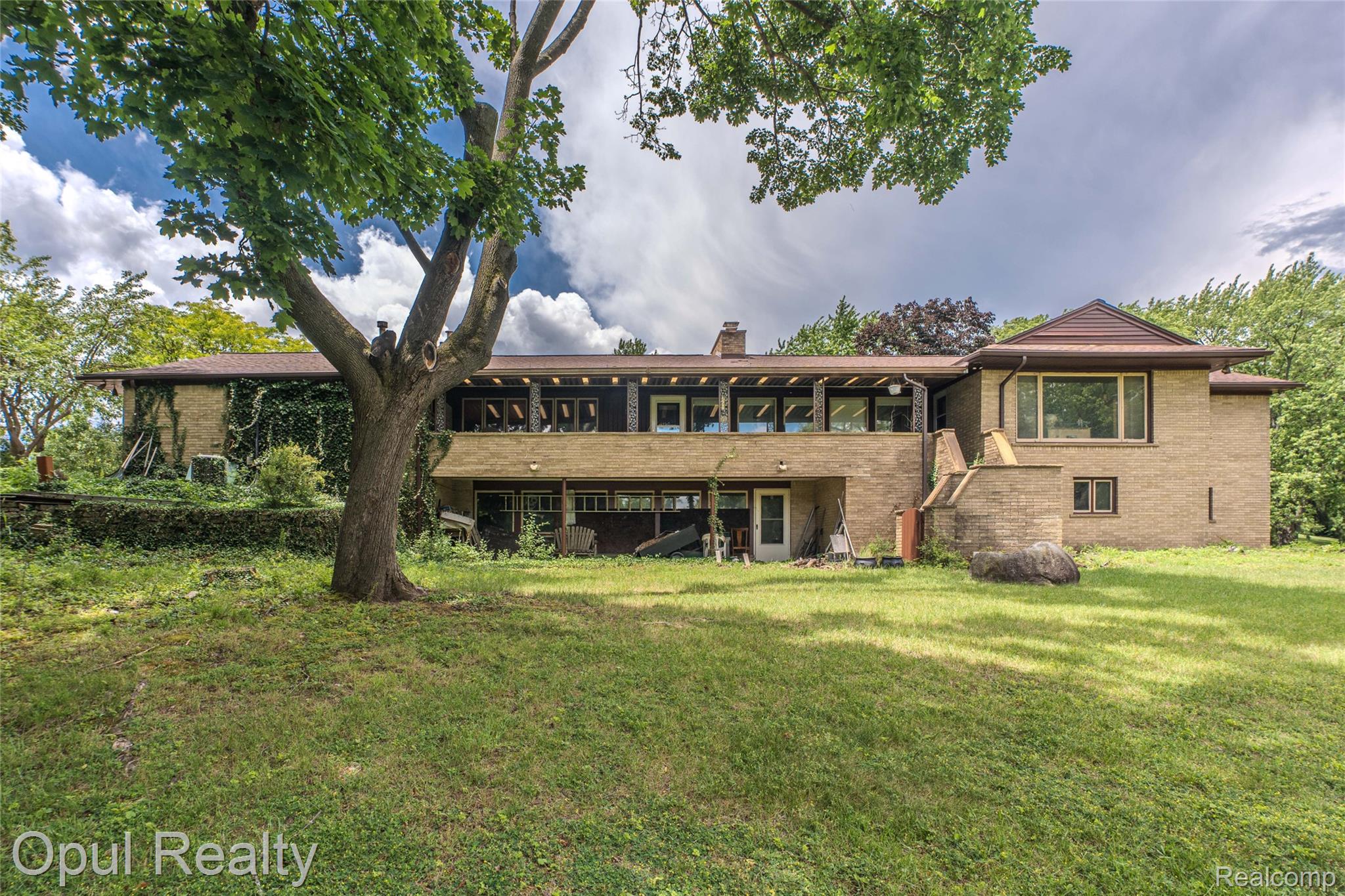 6455 Norham Road Bloomfield Hills, MI 48301 - Photo 8 of 93 Brick exterior featuring multiple levels and a covered upper-level balcony