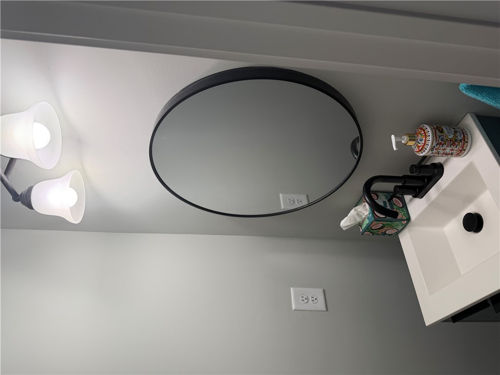 102 Turkey Trot Road Williamston, SC 29697 - Photo 13 of 37 This sleek bathroom features a modern circular mirror and contemporary sink.