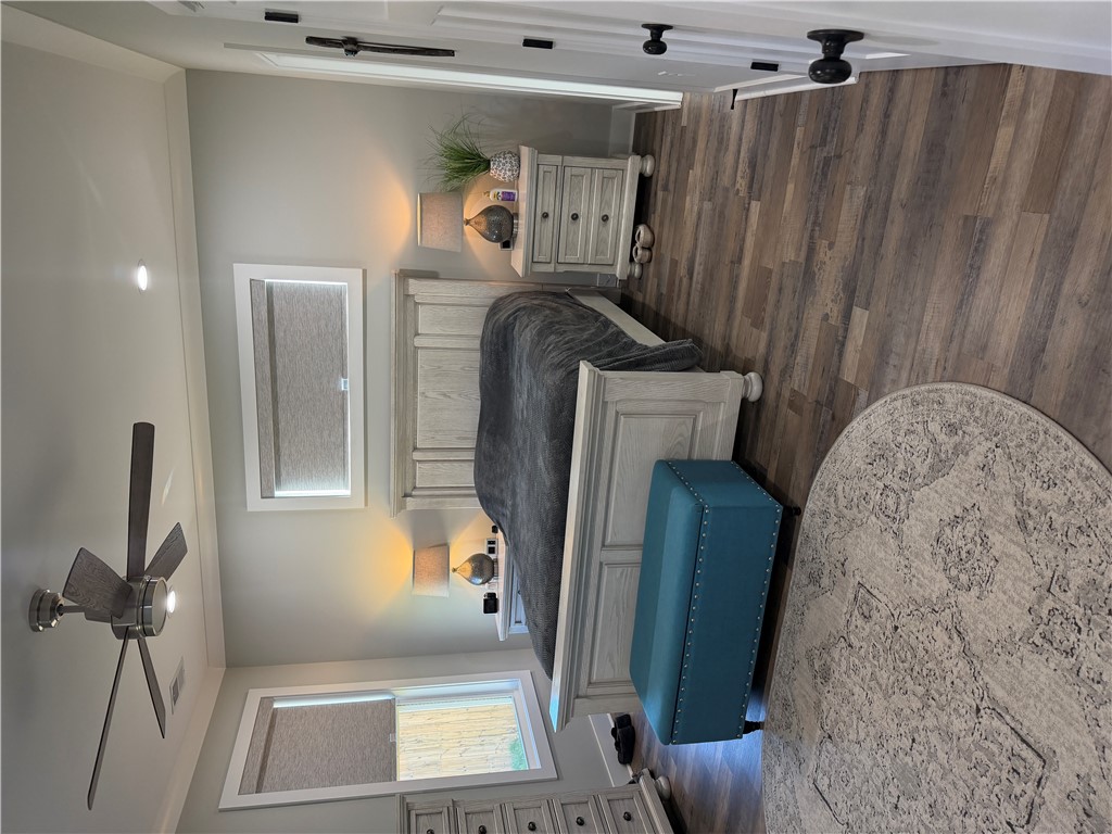 102 Turkey Trot Road Williamston, SC 29697 - Photo 15 of 37 This spacious bedroom features wood flooring, recessed lighting, and a ceiling fan for optimal comfort.