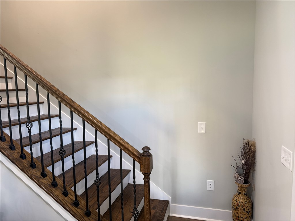 102 Turkey Trot Road Williamston, SC 29697 - Photo 20 of 37 Elegant hardwood stairs with wrought iron balusters elevate this inviting entryway.