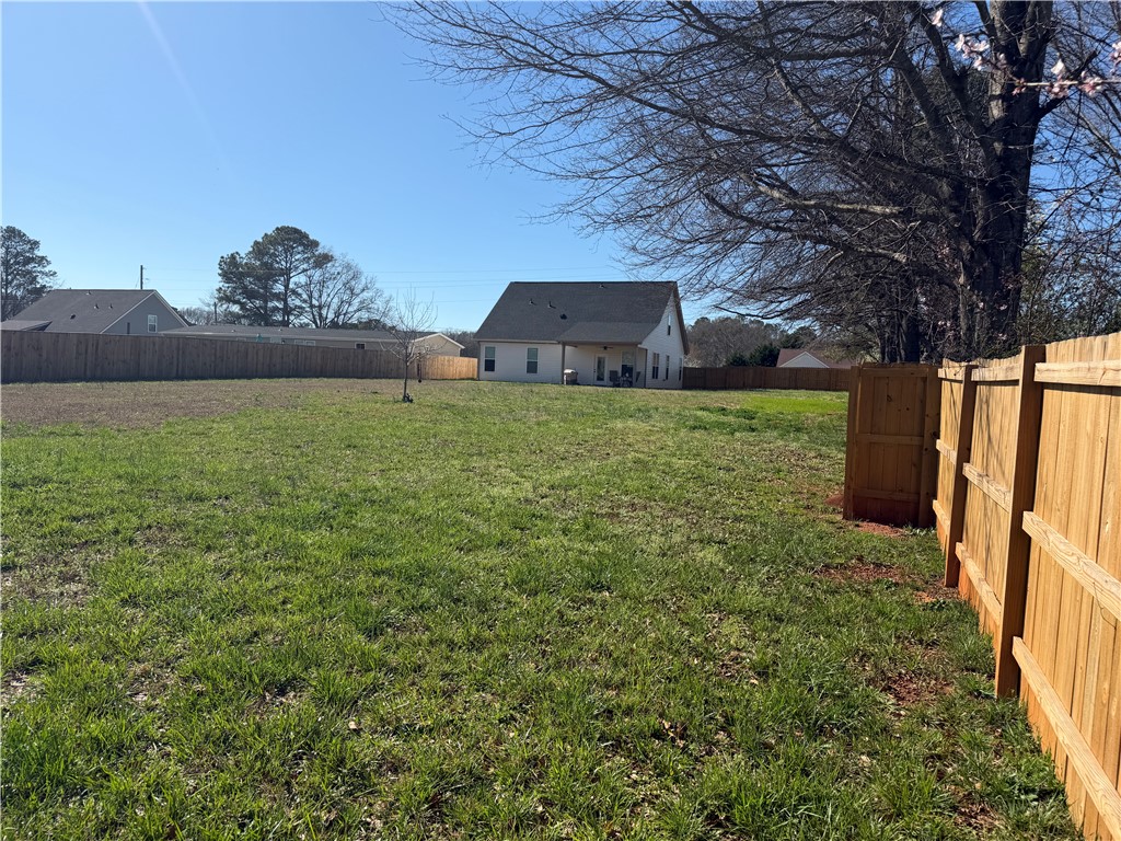 102 Turkey Trot Road Williamston, SC 29697 - Photo 34 of 37 Expansive green lawn with a privacy fence creating an ideal outdoor living space.