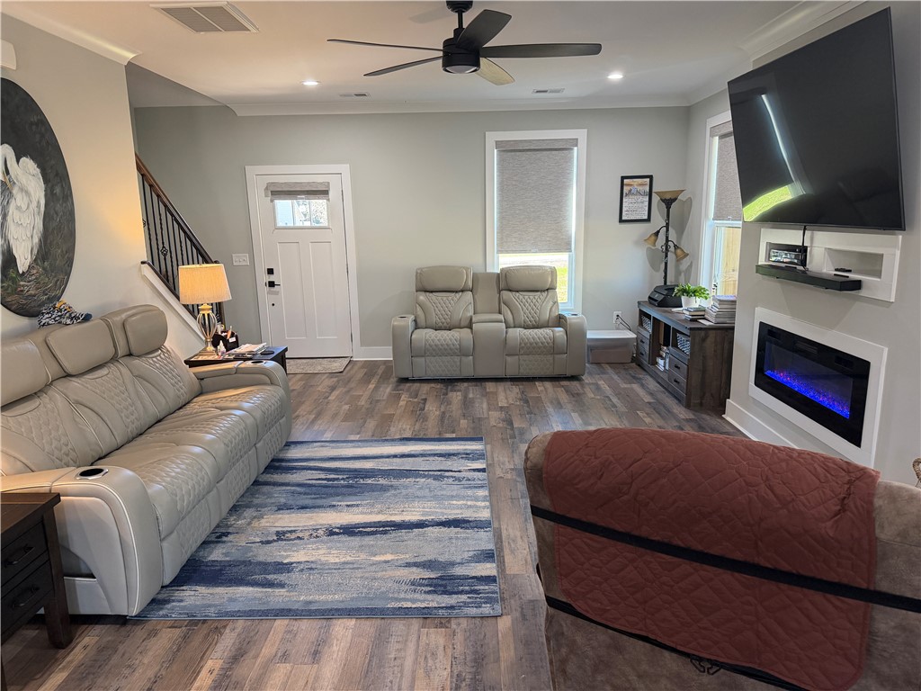 102 Turkey Trot Road Williamston, SC 29697 - Photo 8 of 37 This inviting living space features an electric fireplace and durable wood flooring.