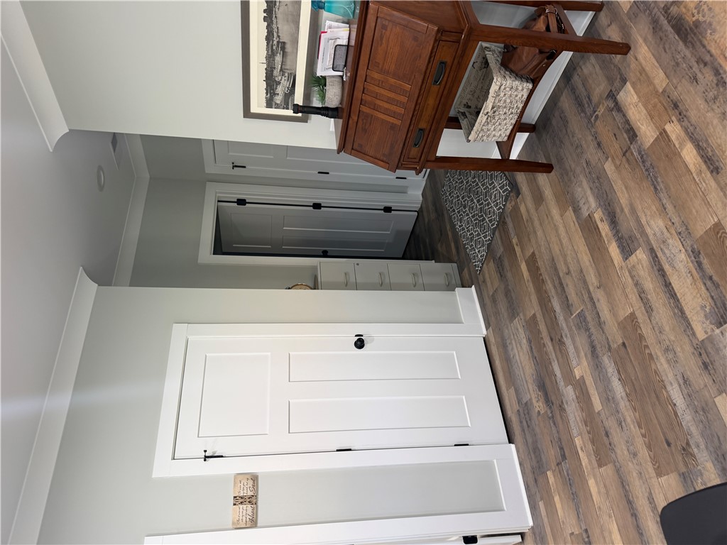 102 Turkey Trot Road Williamston, SC 29697 - Photo 9 of 37 This interior hallway features warm flooring and crown molding, leading to additional rooms.