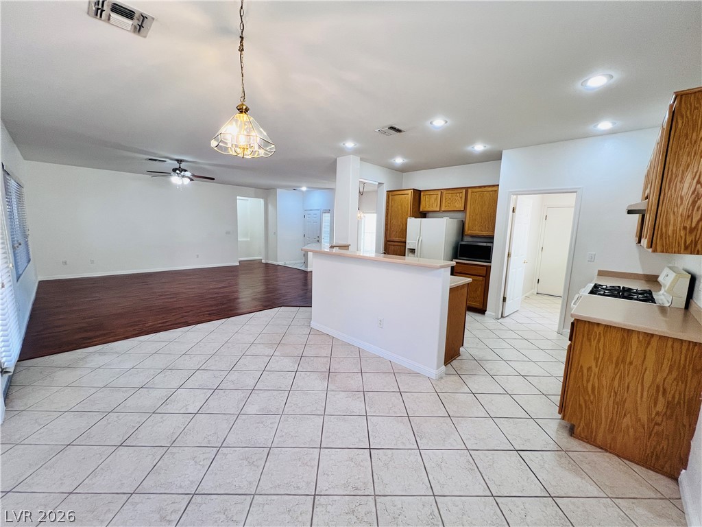 3047 Hickory Valley Road Henderson, NV 89052 - Photo 33 of 33 An open floorplan seamlessly connects the kitchen and living areas, offering functional flow for daily living.