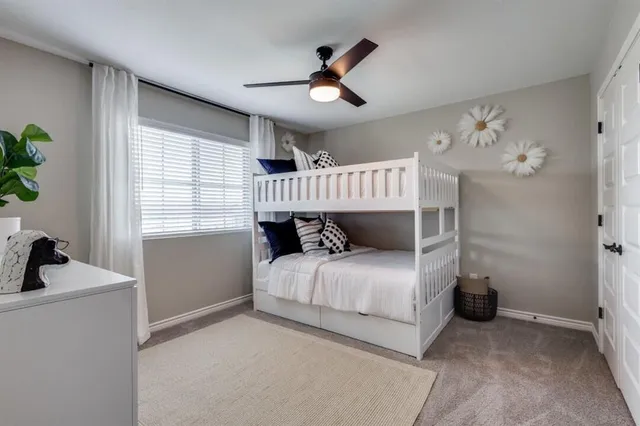 a bedroom with bed and a chandelier