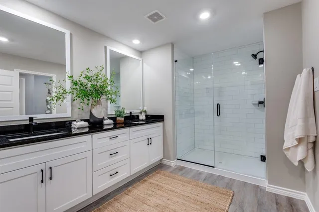 a bathroom with a granite countertop sink a mirror and a