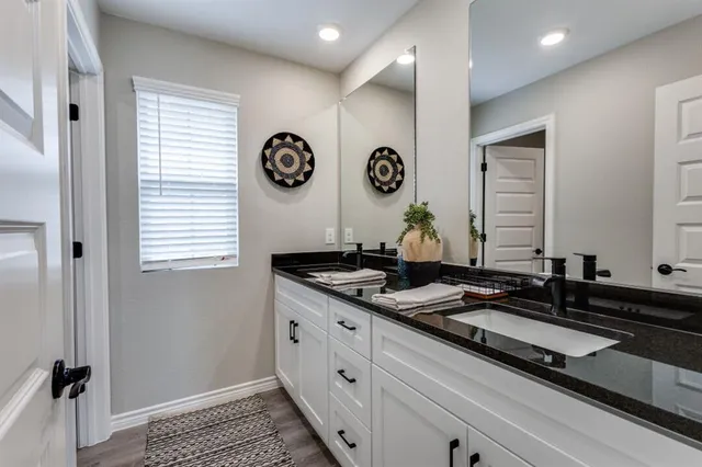 a bathroom with double sink and shower