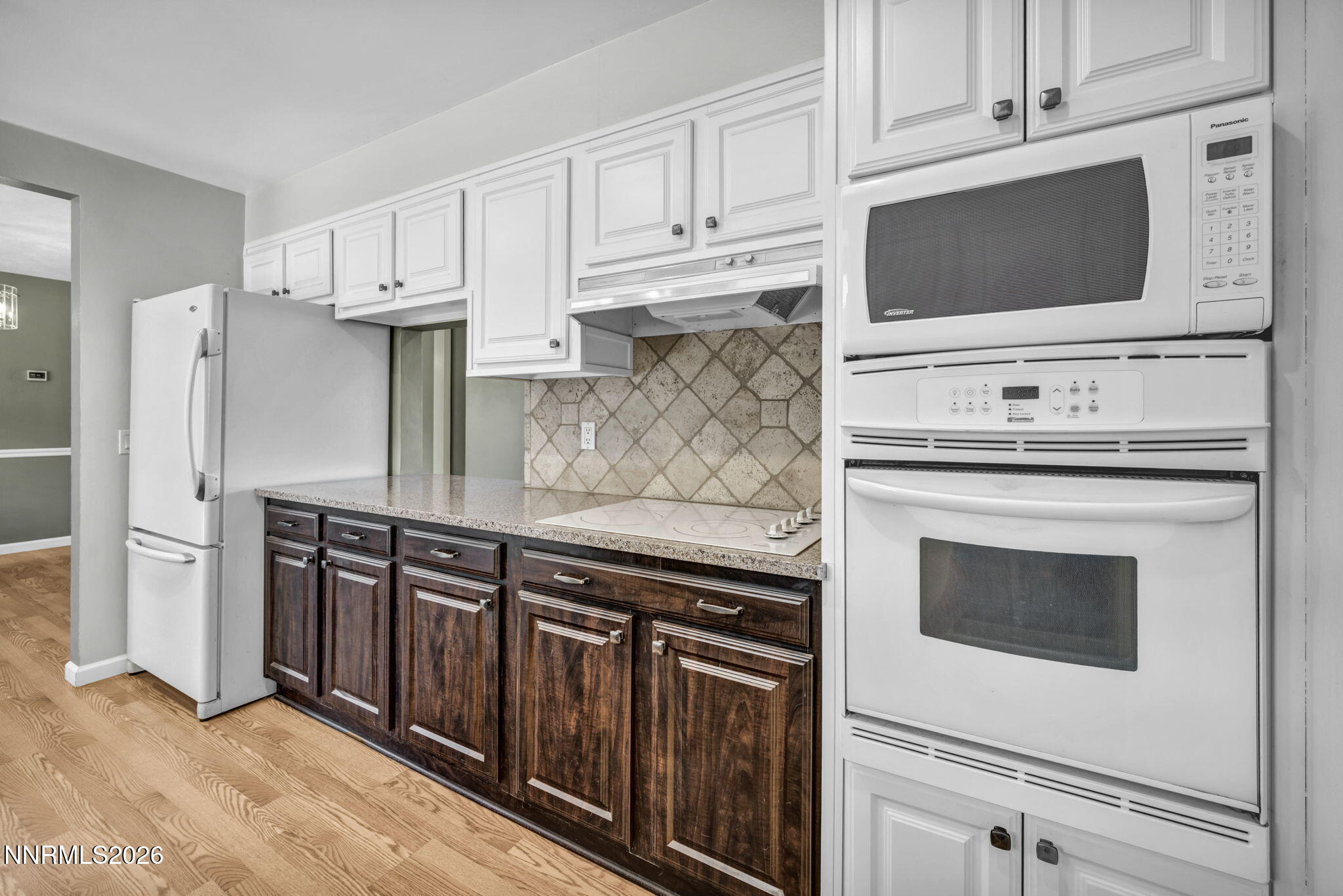 14190 Rim Rock Drive Reno, NV 89521 - Photo 22 of 68 a kitchen with stainless steel appliances a stove microwave and refrigerator