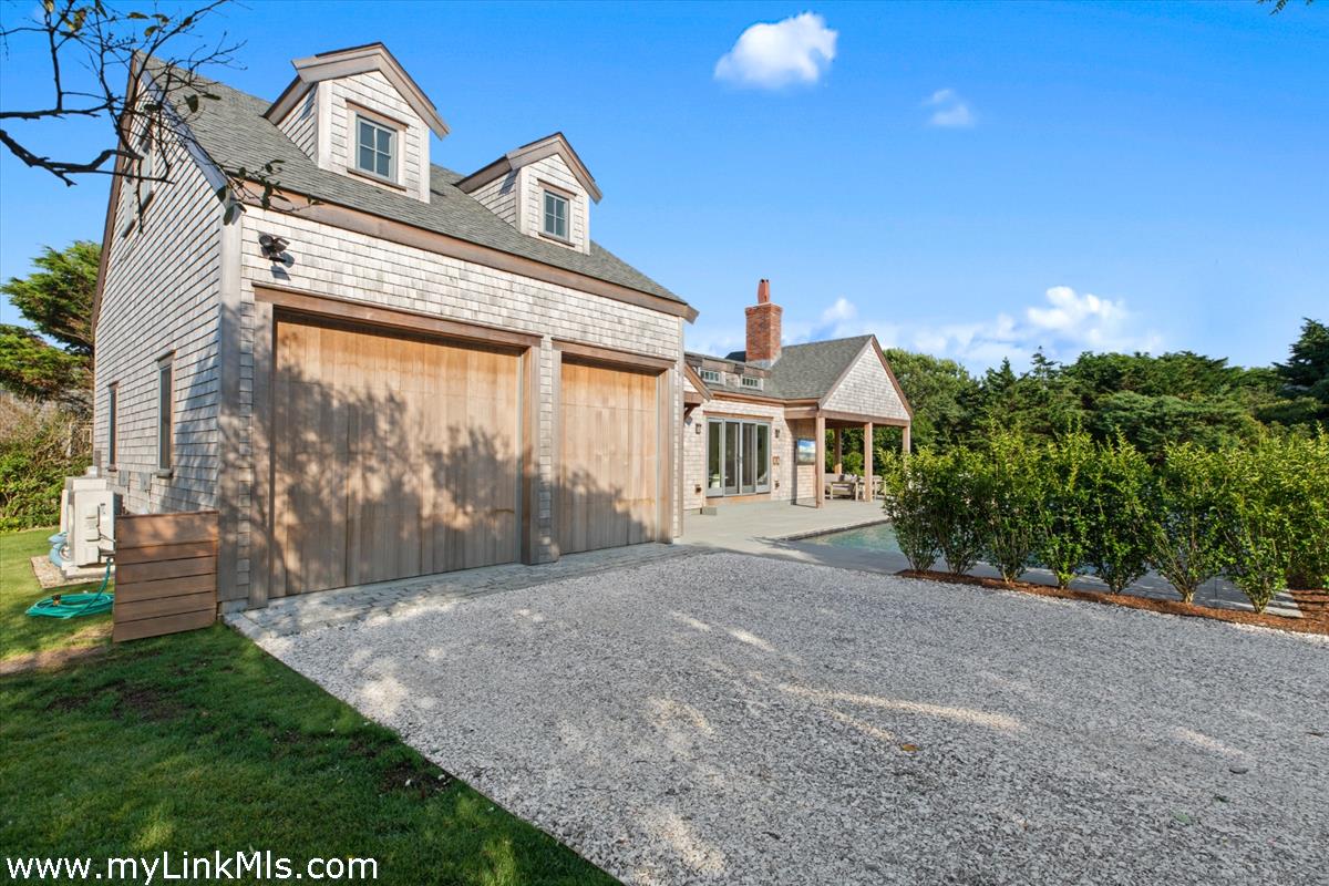 3 Tautemo Way Nantucket, MA 02554 - Photo 55 of 57 a front view of a house with a garden and entryway