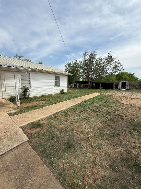 701 Perry Street Santa Anna, TX 76878 - Photo 2 of 13 a view of a house with a yard and street