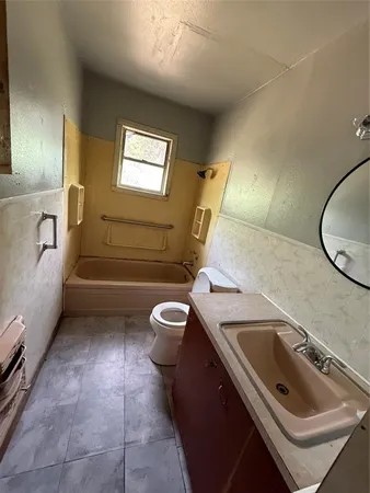 a bathroom with a sink a toilet and bathtub