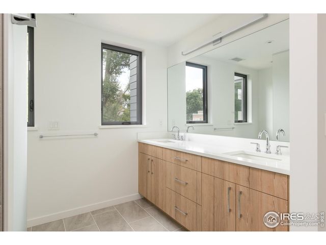 a bathroom with a double vanity sink and mirror