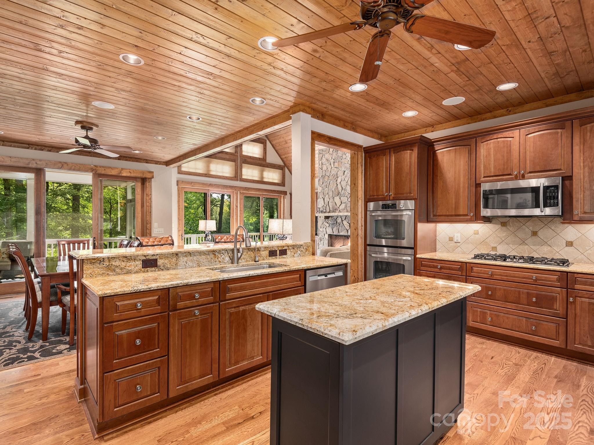 120 Mossy Rock Road Sapphire, NC 28774 - Photo 11 of 47 a kitchen with a stove a sink and a refrigerator