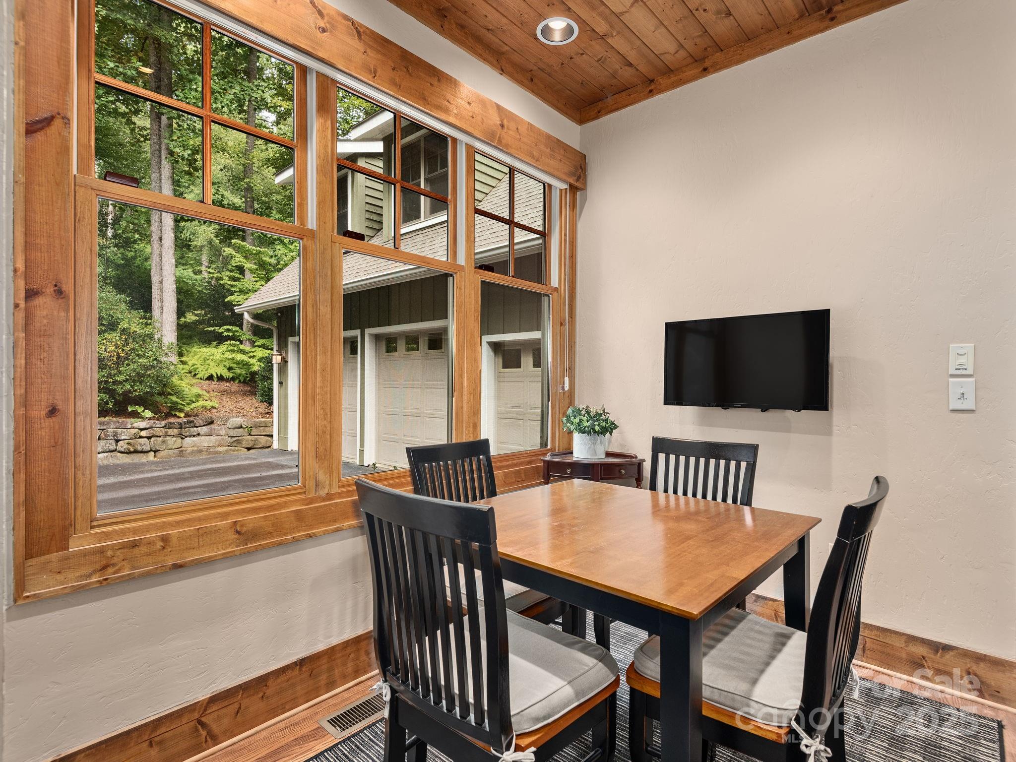 120 Mossy Rock Road Sapphire, NC 28774 - Photo 12 of 47 a view of a dining room with furniture window and wooden floor