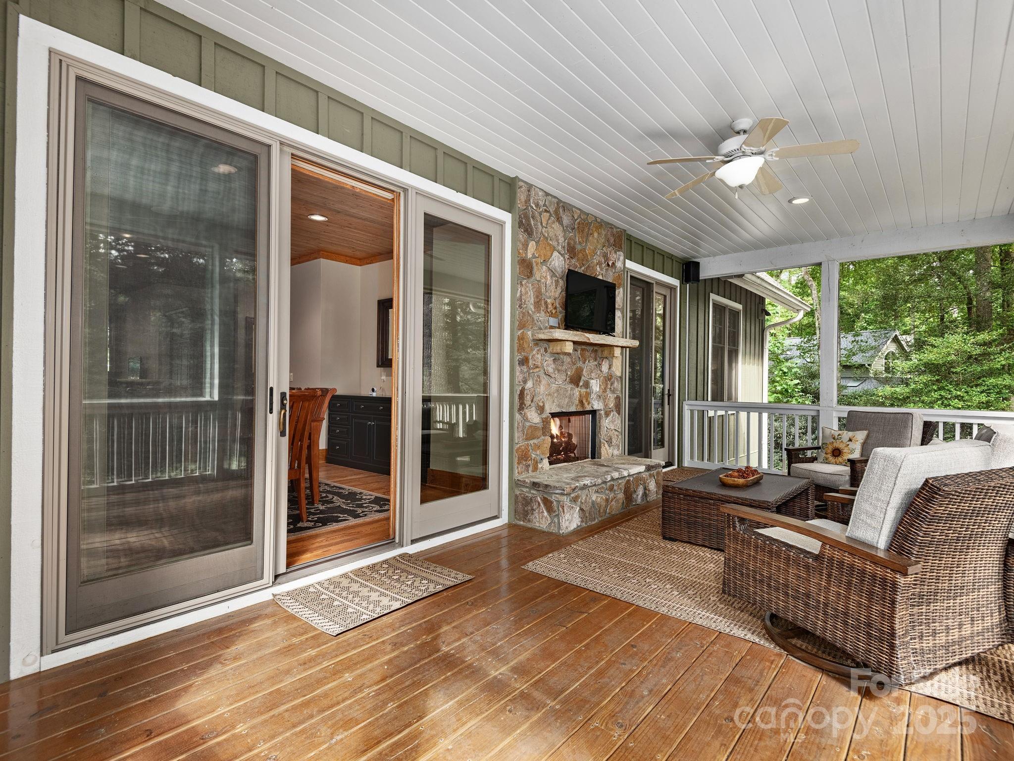 120 Mossy Rock Road Sapphire, NC 28774 - Photo 14 of 47 a living room with furniture and a floor to ceiling window