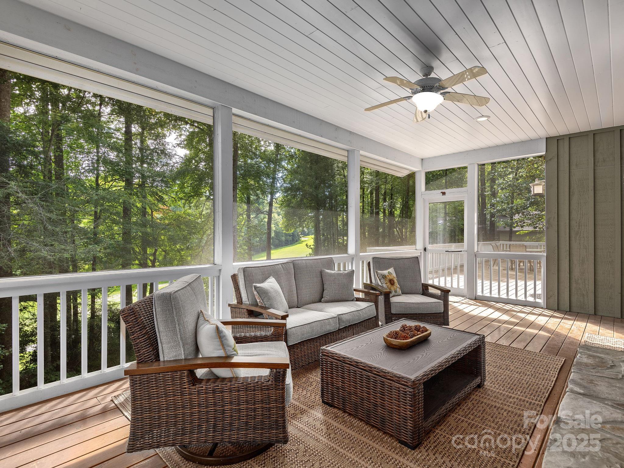 120 Mossy Rock Road Sapphire, NC 28774 - Photo 15 of 47 a living room with furniture and a large window