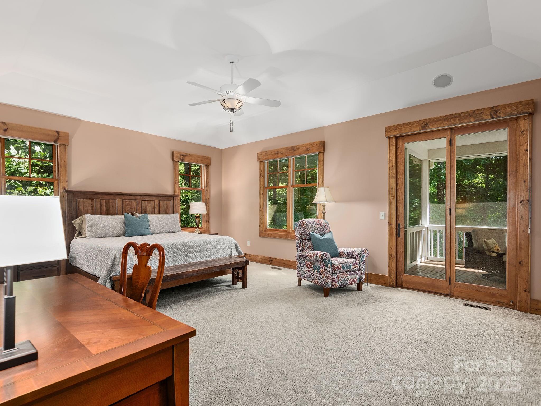 120 Mossy Rock Road Sapphire, NC 28774 - Photo 18 of 47 a bedroom with a bed and glass door