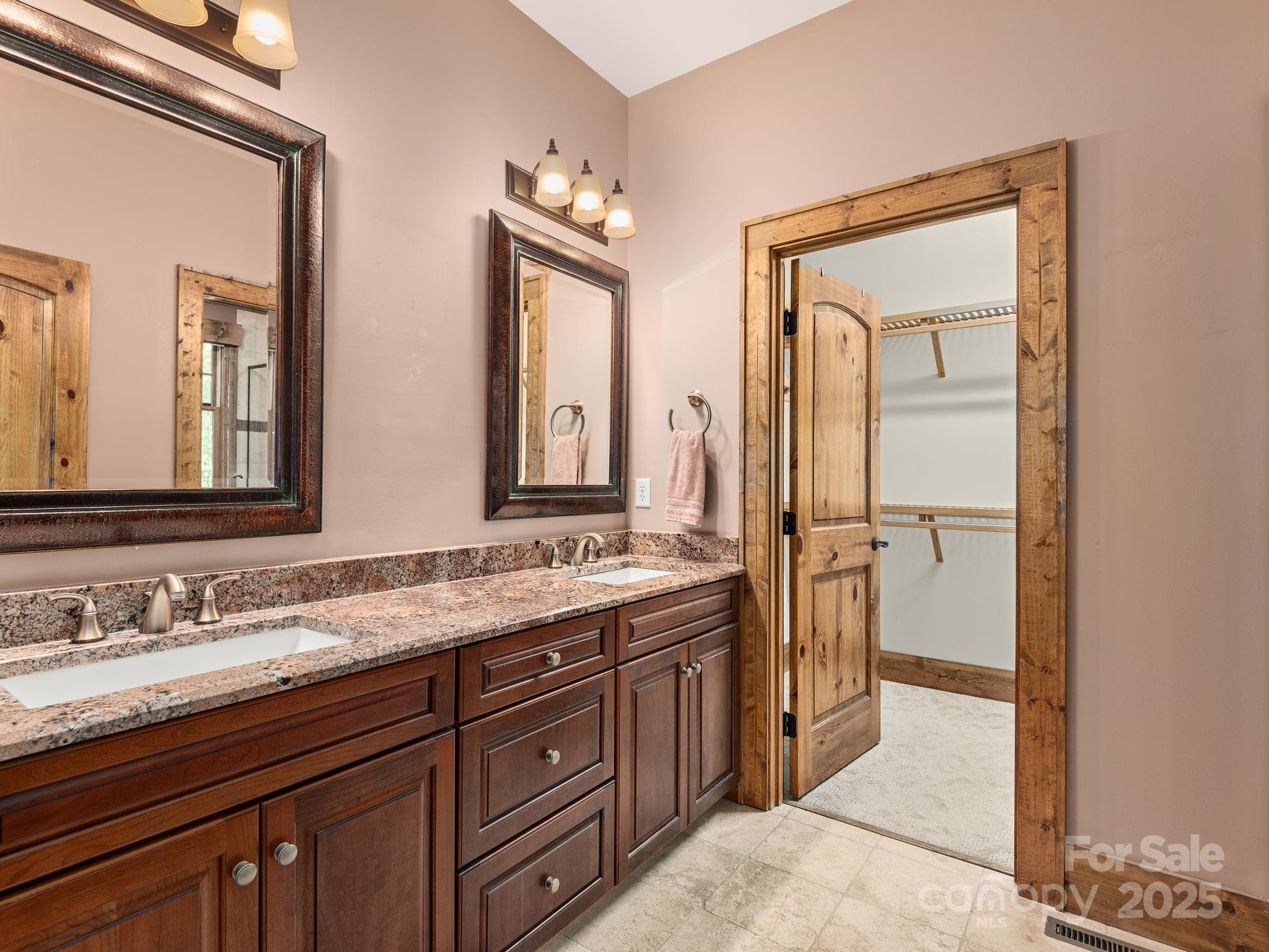 120 Mossy Rock Road Sapphire, NC 28774 - Photo 21 of 47 a bathroom with a granite countertop sink mirror and double