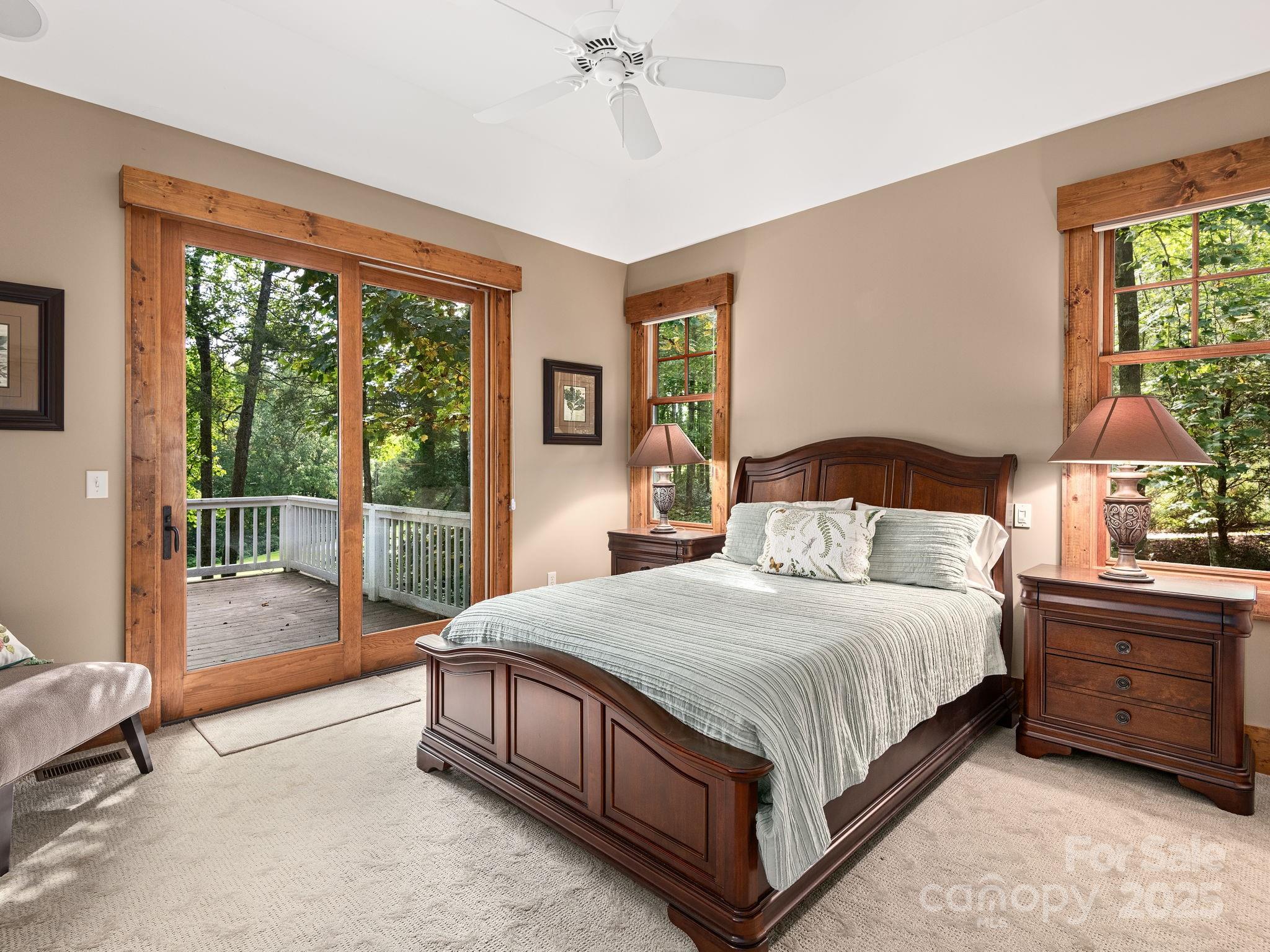 120 Mossy Rock Road Sapphire, NC 28774 - Photo 24 of 47 a bedroom with a bed a lamp and a window