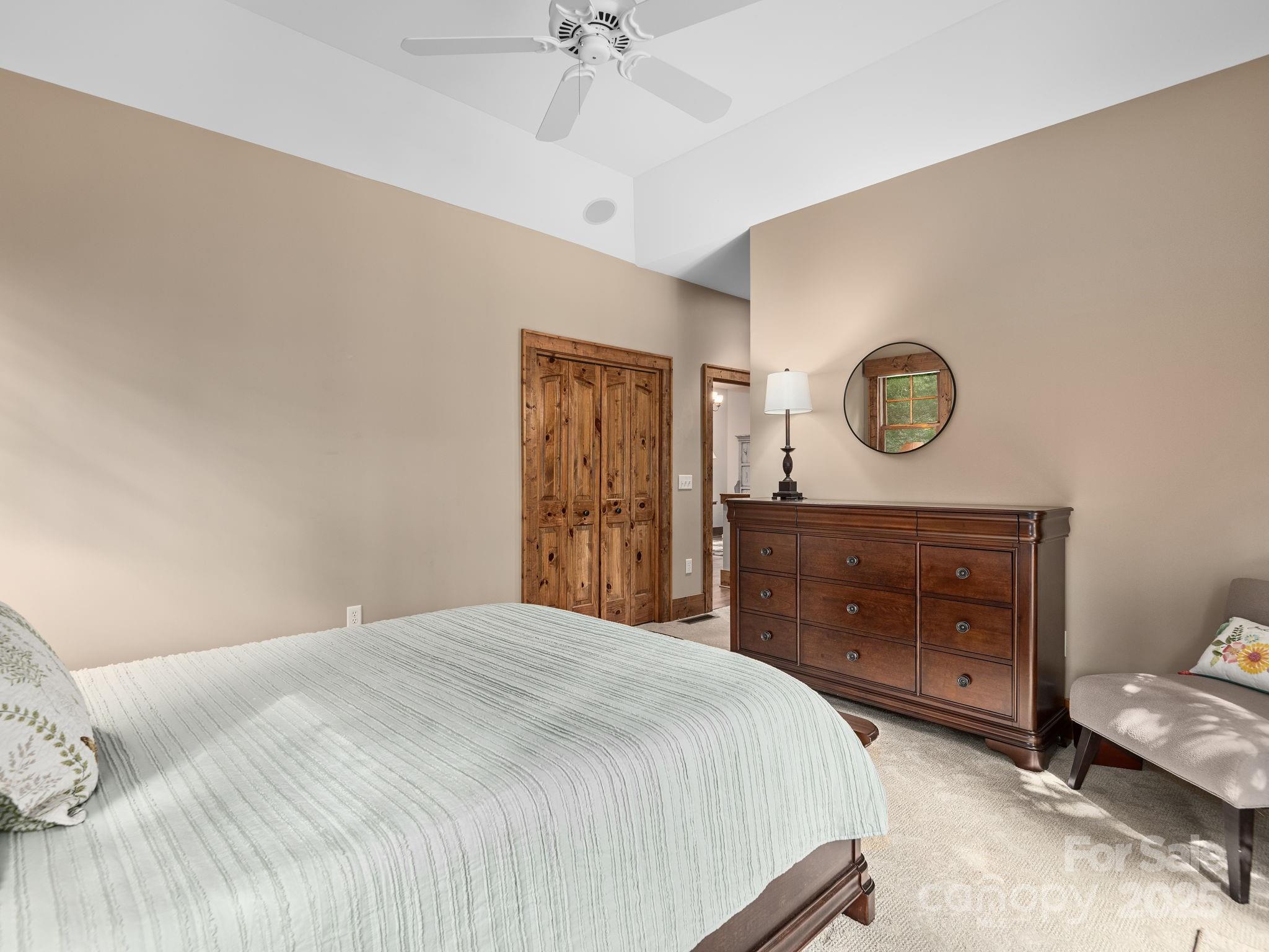 120 Mossy Rock Road Sapphire, NC 28774 - Photo 25 of 47 a bedroom with a bed and a dresser