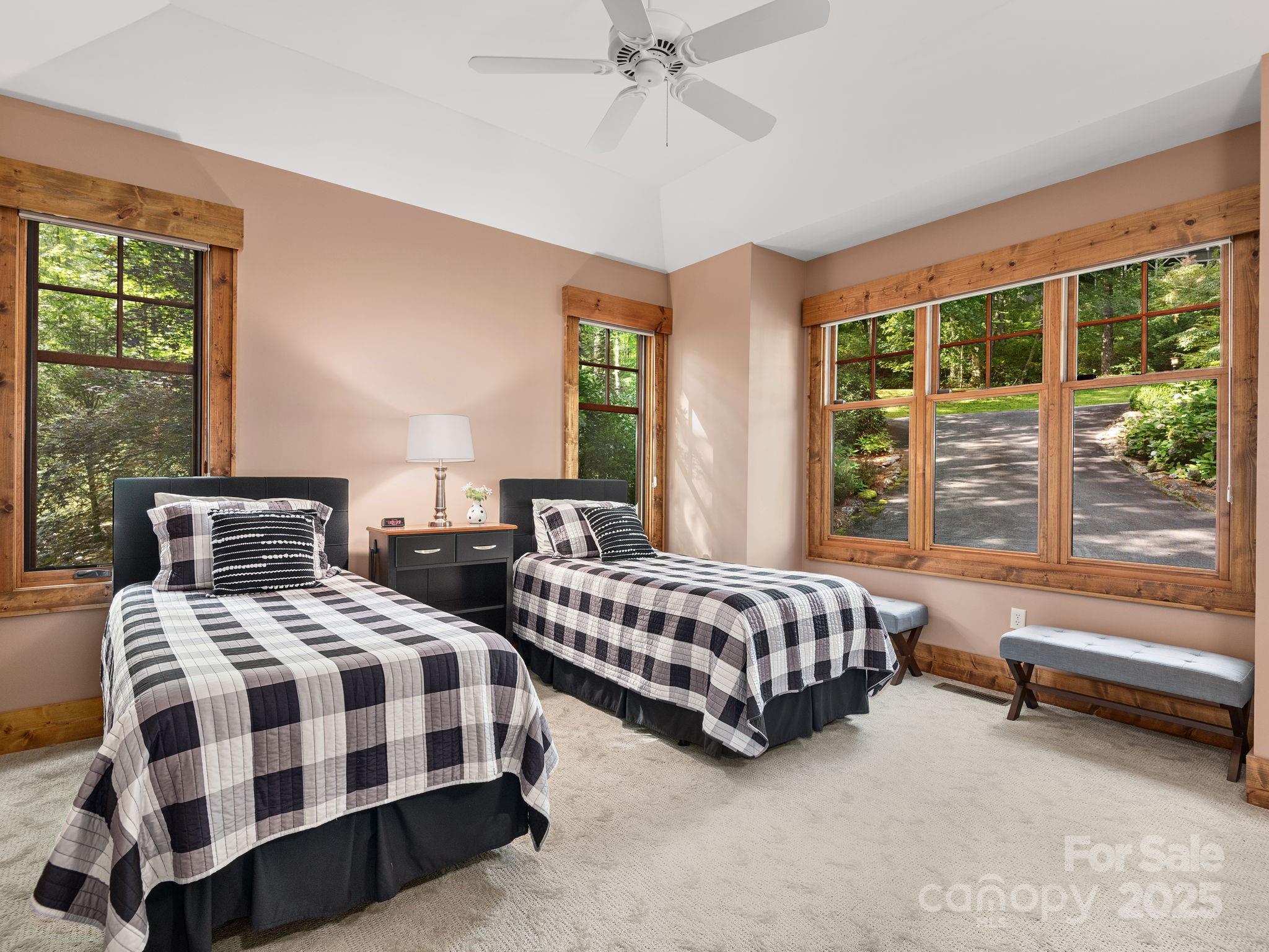 120 Mossy Rock Road Sapphire, NC 28774 - Photo 27 of 47 a bedroom with two beds and a large window