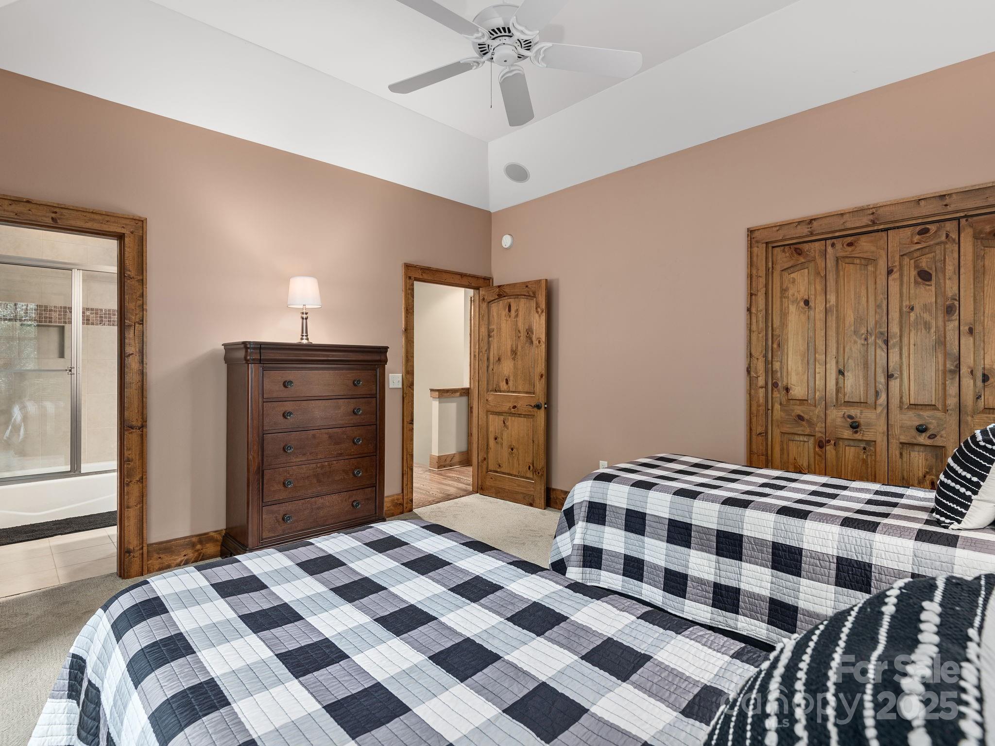 120 Mossy Rock Road Sapphire, NC 28774 - Photo 28 of 47 a bedroom with a bed and a dresser