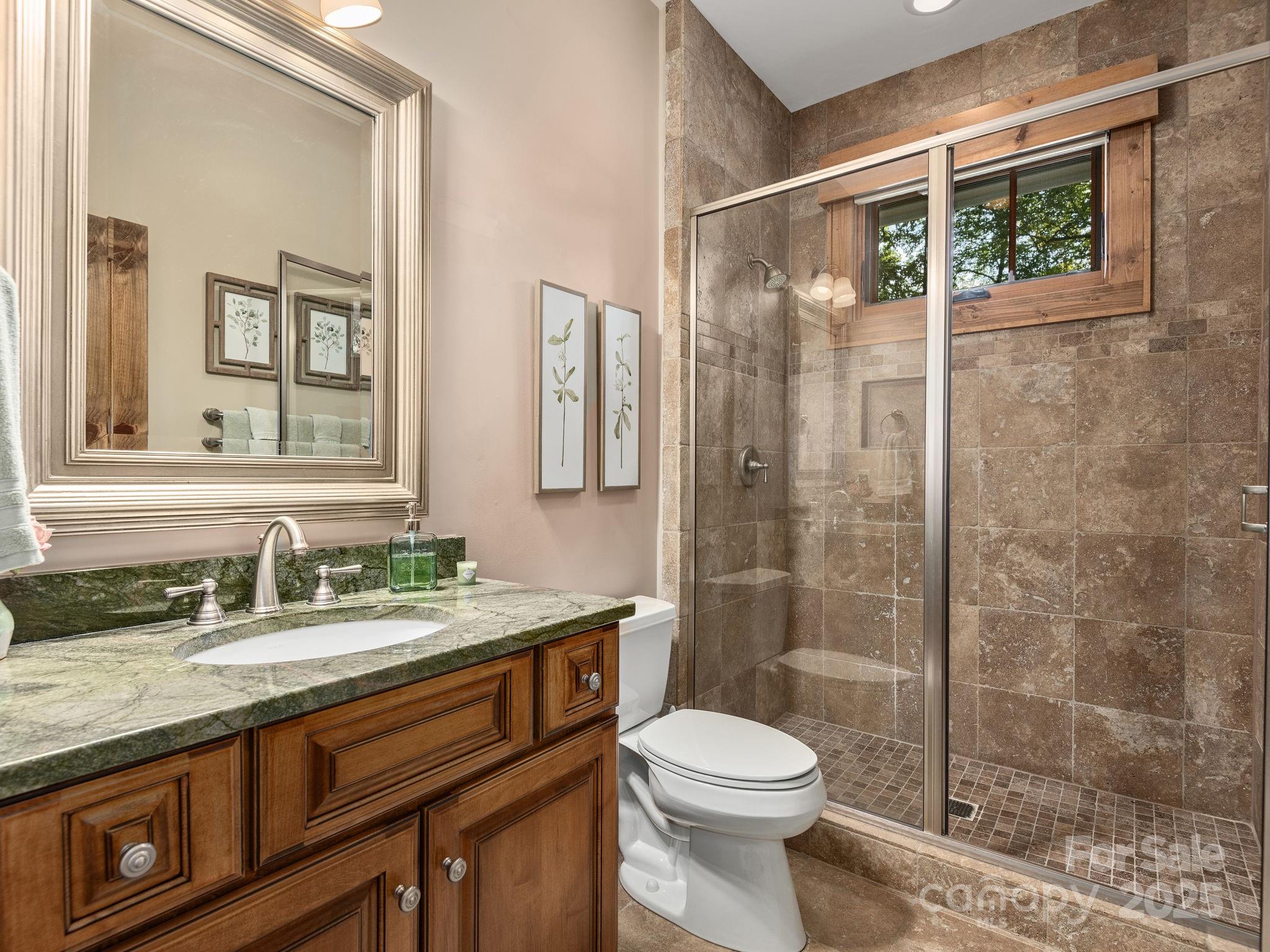 120 Mossy Rock Road Sapphire, NC 28774 - Photo 34 of 47 a bathroom with a granite countertop sink toilet and shower