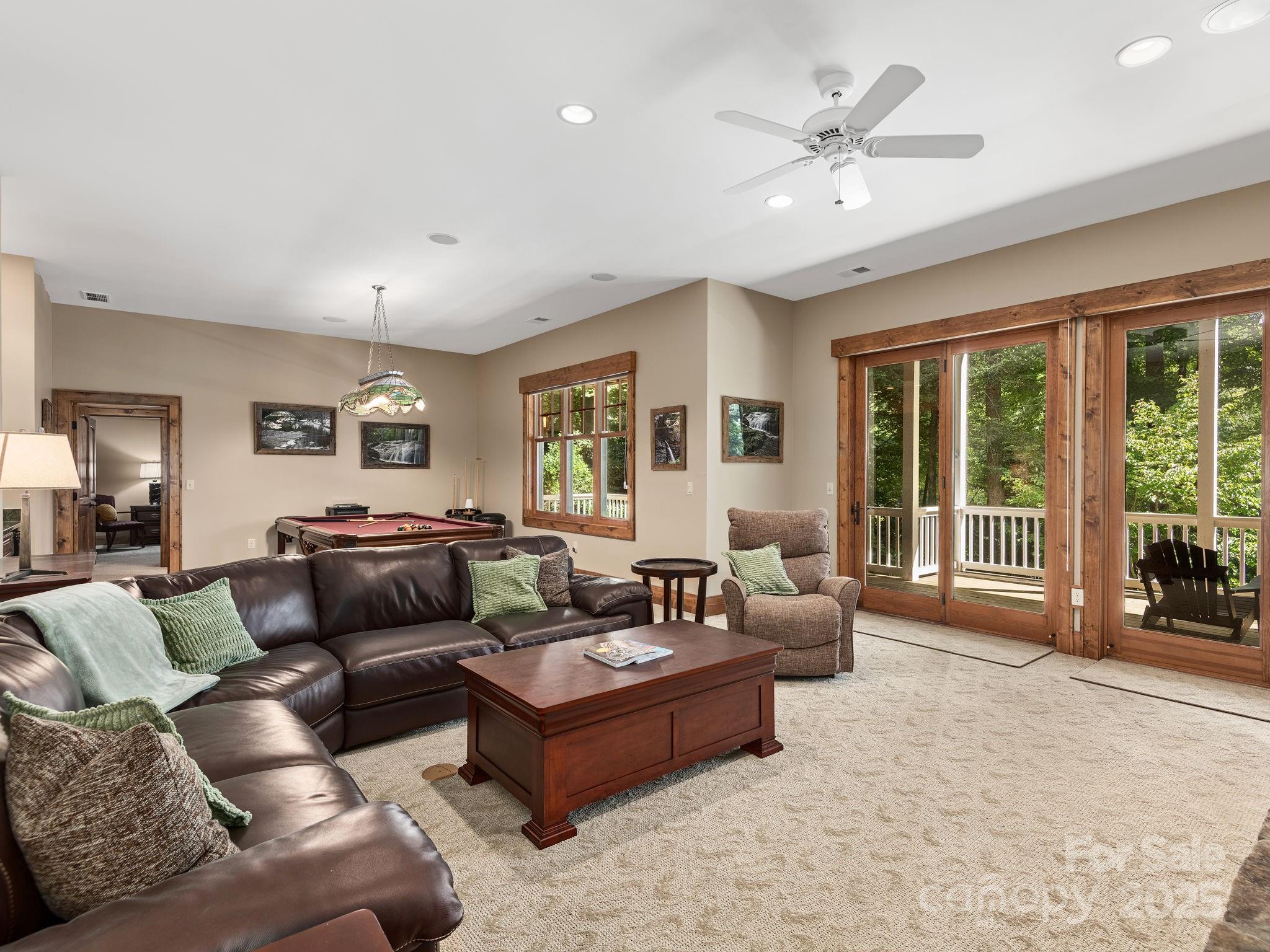 120 Mossy Rock Road Sapphire, NC 28774 - Photo 35 of 47 a living room with furniture and large windows