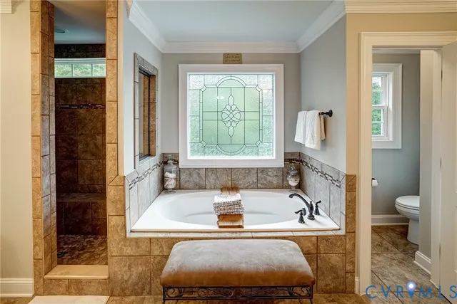 a bathroom with a tub a sink and a large window