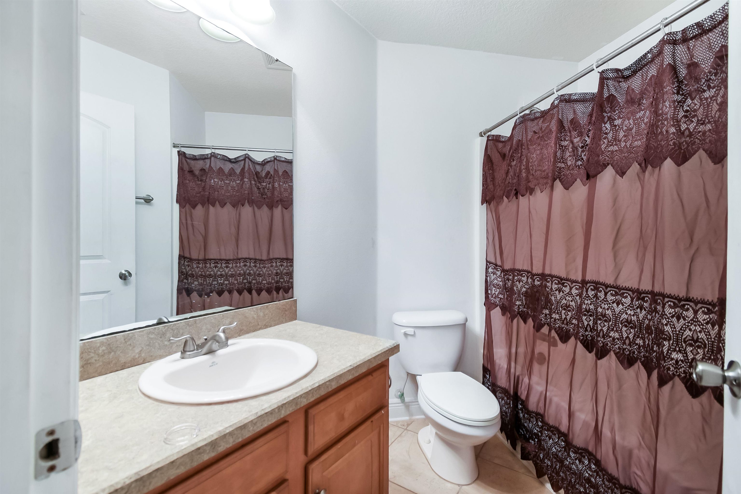 46 Riddle Drive Palm Coast, FL 32164 - Photo 17 of 20 a bathroom with a sink toilet and shower