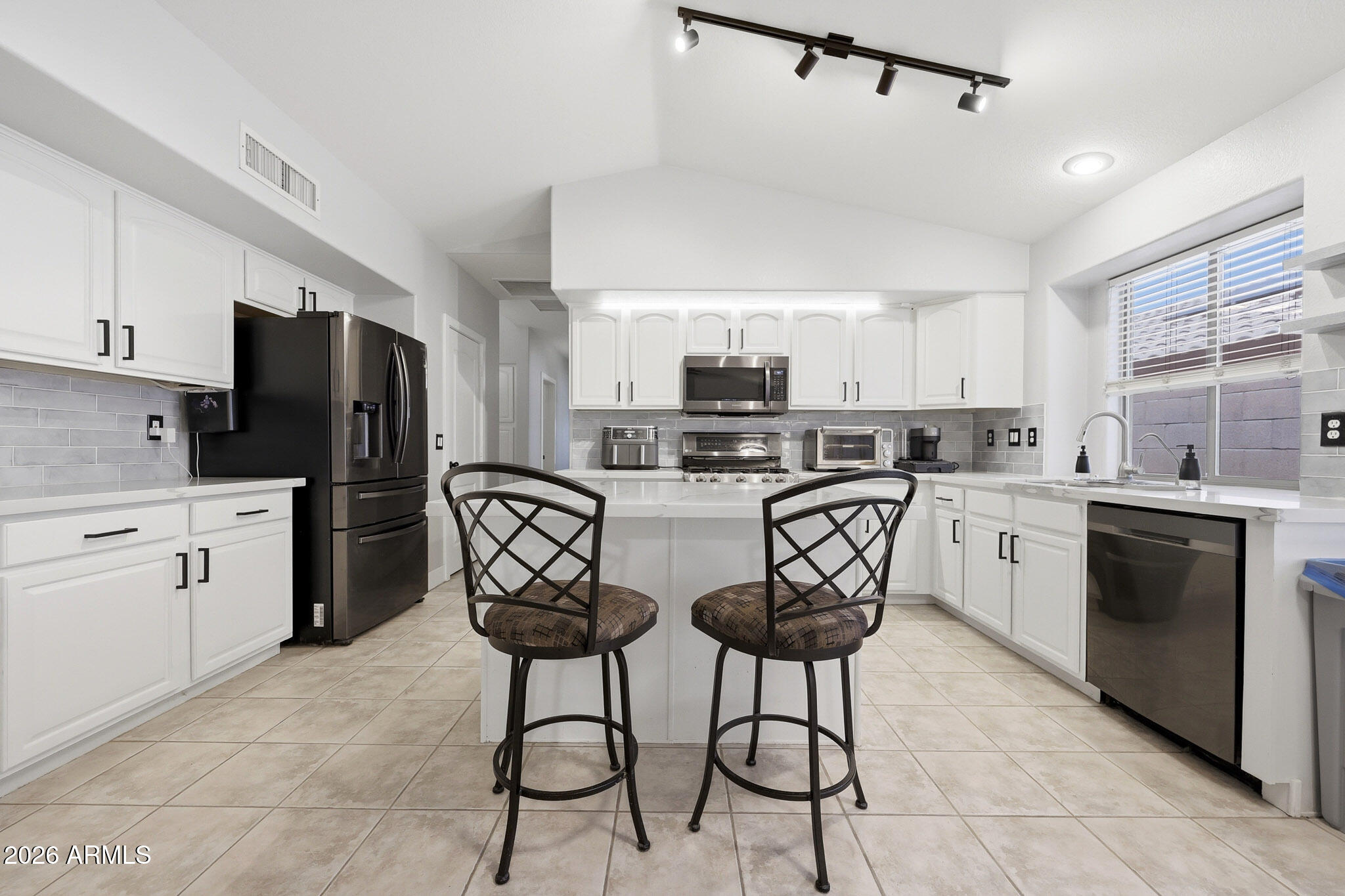 2153 East Kempton Road Chandler, AZ 85225 - Photo 10 of 50 a kitchen with stainless steel appliances a refrigerator stove microwave and cabinets
