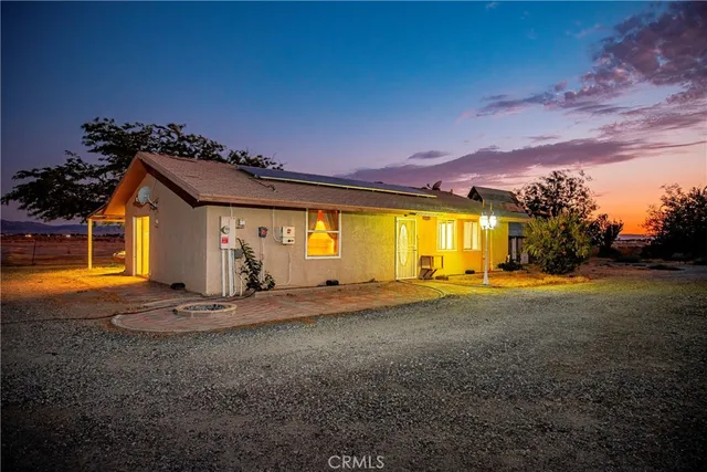a front view of a house with a big yard
