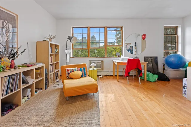 a bedroom with furniture and a large window